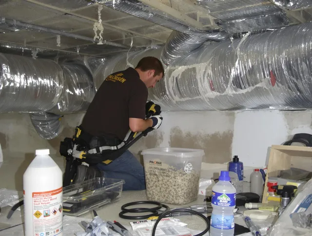 Groton Air Duct Cleaning specialist performing professional mold removal from air ducts in Groton