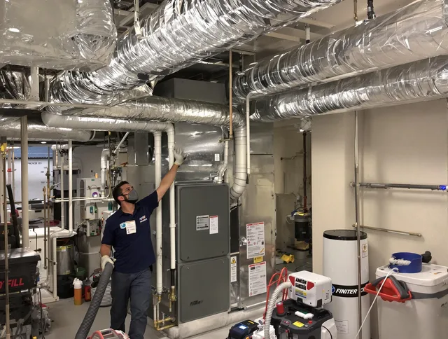 Groton Air Duct Cleaning specialist performing thorough furnace duct cleaning in a Groton residence