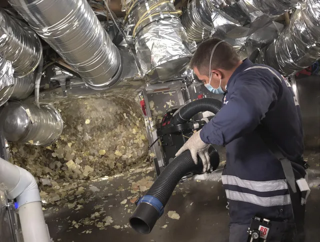 Groton Air Duct Cleaning specialist operating negative pressure cleaning equipment for thorough duct maintenance in Groton
